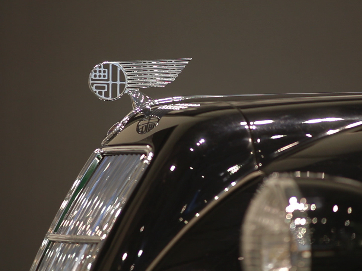 The Toyota emblem adorns the hood of a car.