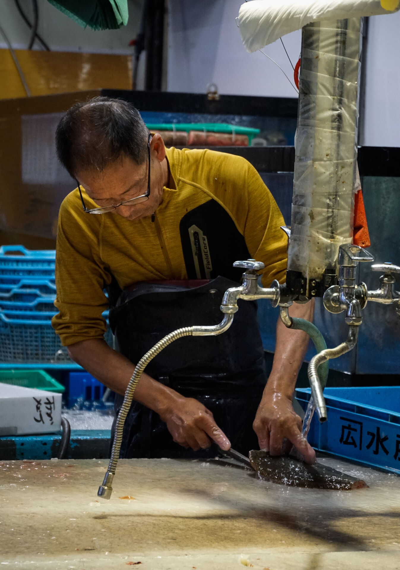 A fishmonger expertly cleans a fish