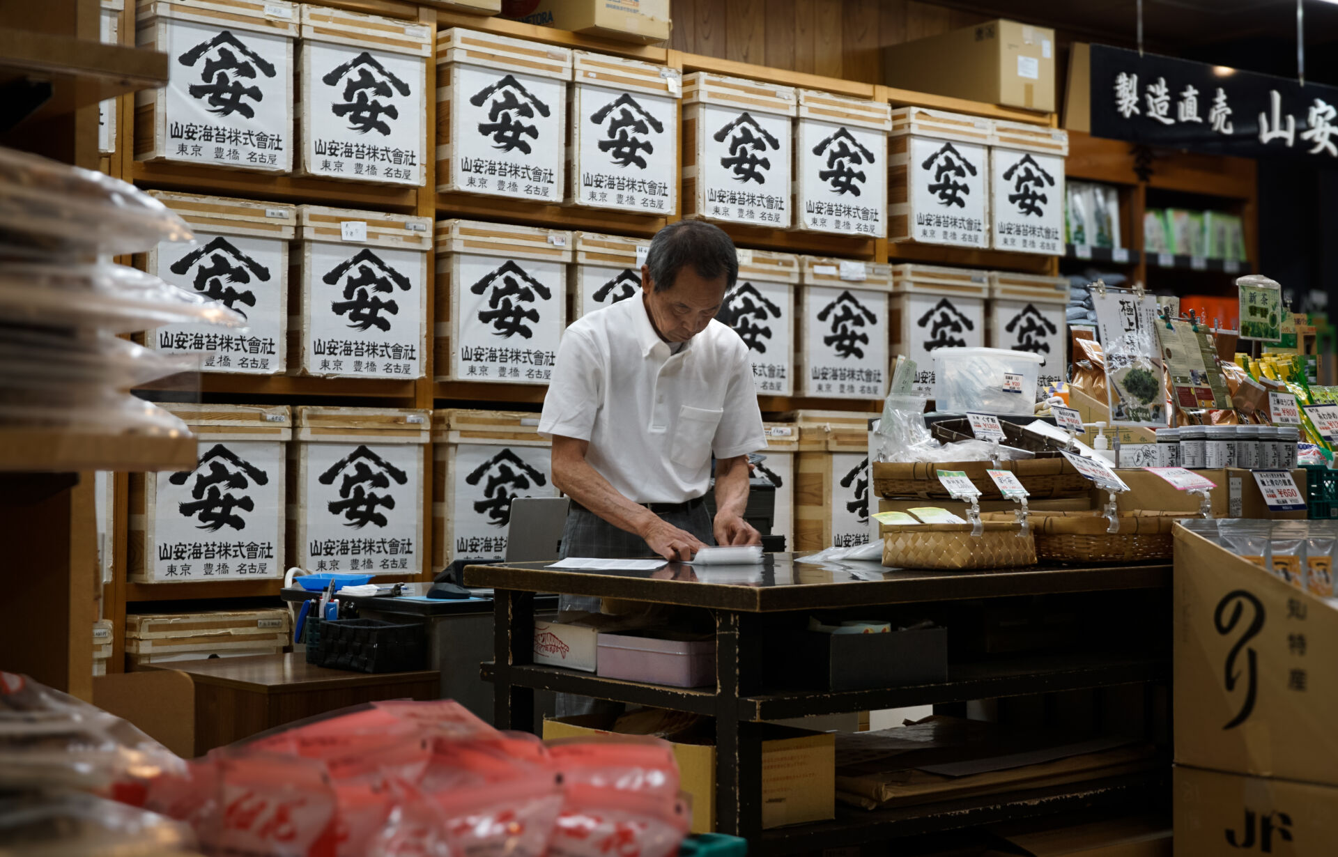A shop owner sorts the day's tea orders in Nagoya